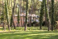 a house in the middle of a field with trees at Le Domaine du Golf de Pinsolle - maeva Home - Appartement 2 pièces 6 person 574 in Soustons