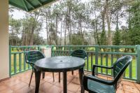 a patio with a table and chairs on a balcony at Le Domaine du Golf de Pinsolle - maeva Home - Appartement 2 pièces 6 person 574 in Soustons