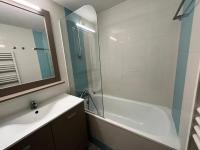 a bathroom with a tub and a sink and a mirror at Les Jonquières - maeva Home - Appartement 2 pièces 4 personnes - Confort 554 in Gassin