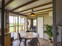 a kitchen and dining room with a table and chairs at Chalet 3 étoiles - Parc aquatique - eecfeb in Saint-Maime