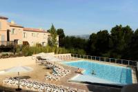 a large swimming pool with chairs and umbrellas at Les Coteaux de Pont Royal en Provence - maeva Home - Appartement 3 pièces 6 214 in Mallemort
