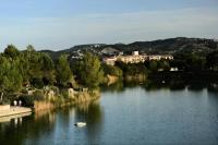 a body of water with buildings in the background at Les Coteaux de Pont Royal en Provence - maeva Home - Appartement 3 pièces 6 214 in Mallemort