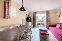 a kitchen and living room with a table and chairs at Les Coteaux de Pont Royal en Provence - maeva Home - Appartement 3 pièces 6 214 in Mallemort