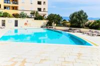 a large swimming pool with chairs and a building at Les Coteaux de Pont Royal en Provence - maeva Home - Appartement 3 pièces 6 214 in Mallemort