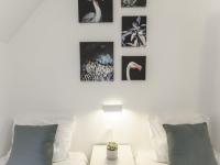 a living room with a white couch and pictures on the wall at Villa Campagne 138 in Daumazan-sur-Arize