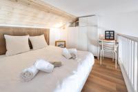 a bedroom with a white bed with towels on it at Résidence Les Horizons D&#39;huez - 2 Pièces pour 4 Personnes 724 in LʼHuez