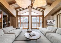 a living room with a couch and a table at Résidence Beloukha - Chalets pour 12 Personnes 734 in Saint-Bon-Tarentaise