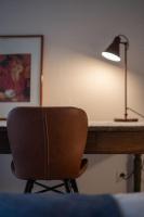 a desk with a chair and a lamp on it at Lovely house with courtyard and terrace near canal du Midi in Trèbes