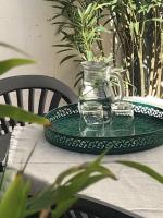 a glass pitcher and two glasses on a table at Lovely house with courtyard and terrace near canal du Midi in Trèbes
