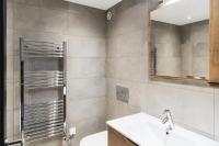 a bathroom with a sink and a mirror at Résidence Le Bercail - Chalets pour 12 Personnes 224 in Saint-Martin-de-Belleville