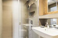 a bathroom with a shower and a sink and a mirror at Résidence Le Bercail - Chalets pour 12 Personnes 224 in Saint-Martin-de-Belleville