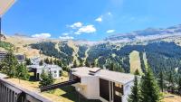 a house with a view of a mountain at Résidence Andromede - Studio pour 4 Personnes 05 in Flaine