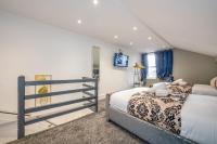a bedroom with two beds and a tv at *RA10W* For your most relaxed &amp; Cosy stay + Free Parking + Free Fast WiFi * in Belle Isle