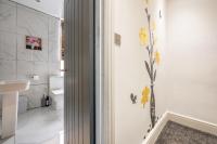a bathroom with yellow flowers on the wall at *RA10W* For your most relaxed &amp; Cosy stay + Free Parking + Free Fast WiFi * in Belle Isle