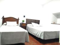 Posteľ alebo postele v izbe v ubytovaní Hostal Cuzco