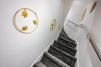 a staircase in a house with a gray carpet at *RB10W* For your most relaxed &amp; Cosy stay + Free Parking + Free Fast WiFi * in Belle Isle