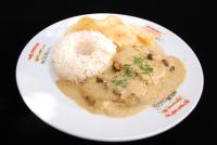 a plate of food with rice and chicken and a doughnut at Hotel Boutique La Posada in Sucre