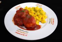 a plate of food with meat and scrambled eggs at Hotel Boutique La Posada in Sucre