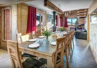 a dining room with a wooden table and chairs at Chalet Sicoria - Les Congères in Le Grand-Bornand
