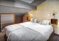 a bedroom with a large white bed in a room at Chalet Sicoria - Les Congères in Le Grand-Bornand