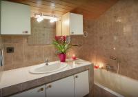 a bathroom with a sink and a vase of flowers at Chalet Sicoria - Les Congères in Le Grand-Bornand