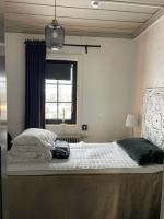 a large bed in a bedroom with a window at Villa Lyckan in Söråker