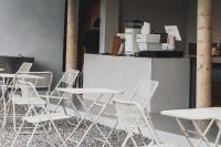 a group of white chairs and tables in a room at Mist Villa in Chiang Dao