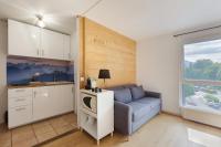 a living room with a couch and a kitchen at Outa B 513 - Happy Rentals in Chamonix