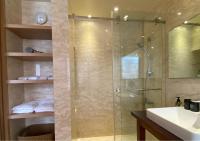 a bathroom with a glass shower with a sink at Beitou Sweet Me Hot Spring Resort in Taipei