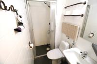 a bathroom with a shower and a toilet and a sink at Forenom Aparthotel Lahti in Lahti