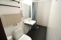 a bathroom with a white toilet and a sink at Forenom Aparthotel Lahti in Lahti
