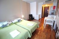 a hotel room with two beds and a table at Forenom Aparthotel Lahti in Lahti