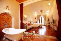 a bathroom with a tub and a living room at Kenting Tuscany Resort in Kenting