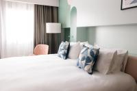 A bed or beds in a room at voco Madrid Retiro by IHG