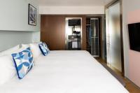 A bed or beds in a room at voco Madrid Retiro by IHG