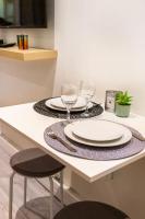 a table with plates and wine glasses on it at Condamine&#47;Batignolles : Cosy Studio in Paris