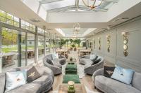 a living room with couches and tables and windows at Farma Bii in Brzeziny