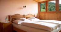 two white beds in a room with a window at Bio Ferienbauernhof Greber in Schwarzenberg