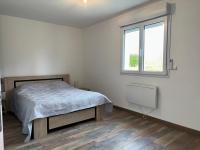 a bedroom with a bed and a window at Les clés de jonzac-conciergerie la maison des 4 Saisons in Ozillac