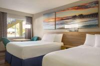 Ein Bett oder Betten in einem Zimmer der Unterkunft Days Inn by Wyndham Cocoa Beach Port Canaveral