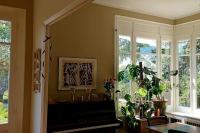 a living room with windows and a potted plant at Maison de maître parc privé proche Crest et Drôme. in Crest