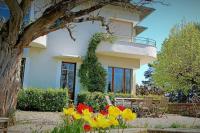 a white house with flowers in front of it at Maison de maître parc privé proche Crest et Drôme. in Crest