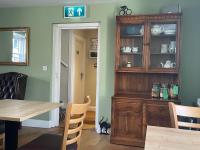 a dining room with a wooden hutch and a table at The Plough Inn Leitholm in Coldstream