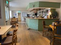 a restaurant with a bar and some tables and chairs at The Plough Inn Leitholm in Coldstream