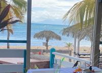 a table with a view of the beach at Le 35 Anse des Rochers Saint-François in Saint-François