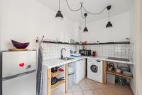a kitchen with a refrigerator and a washing machine at Appartements hyper-centre de Marseille in Marseille