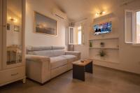 Televízia a/alebo spoločenská miestnosť v ubytovaní Apartments Casa Vecchia