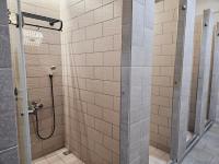 a bathroom with a shower with a glass door at Meeting Mates Hostel in Taipei