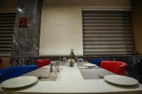 a table with chairs and a white table cloth at Ramada Plaza by Wyndham Lucknow in Lucknow