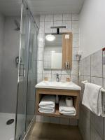 a bathroom with a sink and a shower at Hôtel NOROTEL in Brumath